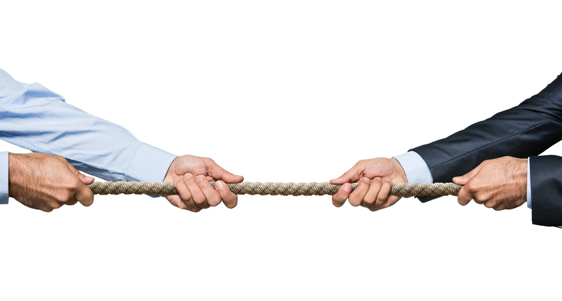 Two businessmen pulling a rope in opposite directions isolated on white background